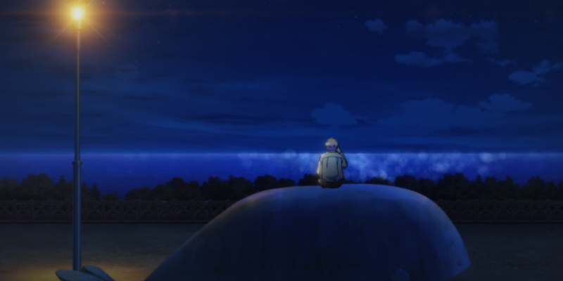 Airu sitting at the whale park on his phone in Anyway I'm Falling In Love With You
